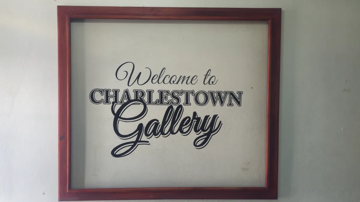Hand-painted "Welcome to Charlestown Gallery" sign at the gallery entrance